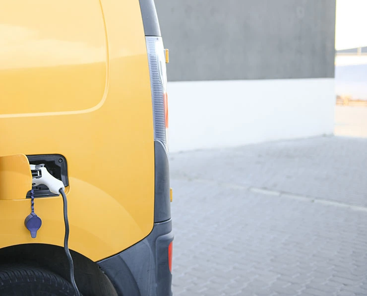 Electric van being charged - sustainability opportunities for green freight in 2024